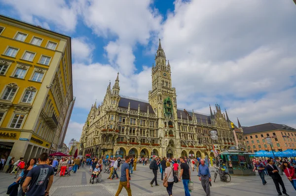 Munich, Germany - July 30, 2015: Famous city hall building with its tall tower sticking up, located on main square, beautiful architectural details and facade