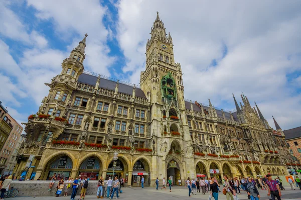 Munich, Germany - July 30, 2015: Famous city hall building with its tall tower sticking up, located on main square, beautiful architectural details and facade