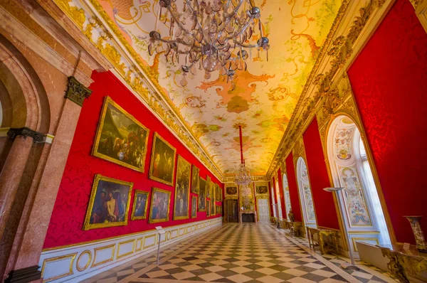 Schleissheim, Germany - July 30, 2015: Royal room inside palace with chandelier, amazing fresco painting, golden framed paintings and gold covered details