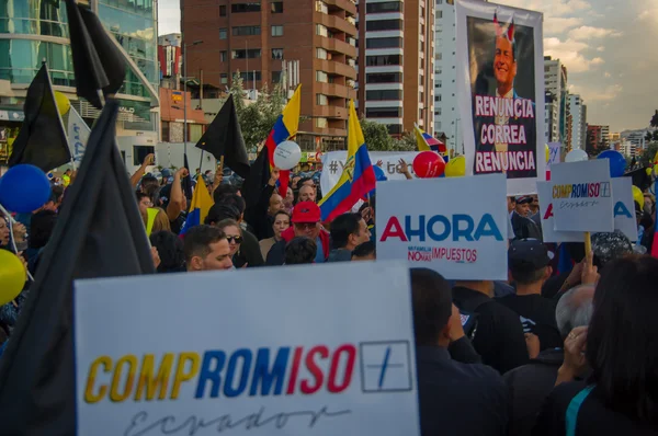 Quito, Ecuador - April 7, 2016: Group of people Holding protest signs, police and journalists during anti government protests in Shyris Avenue