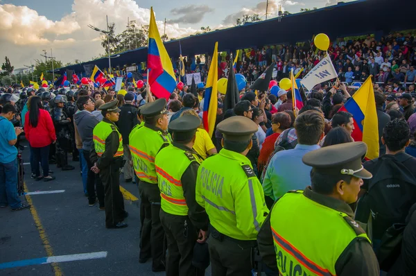 Quito, Ecuador - April 7, 2016: Police awaiting overlooking peaceful anti government protests in Shyris Avenue, beautiful blue sky and buildings background