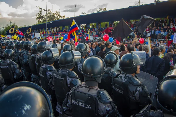 Quito, Ecuador - April 7, 2016: Police awaiting overlooking peaceful anti government protests in Shyris Avenue, beautiful blue sky and buildings background