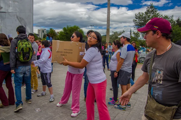 Quito, Ecuador - April,17, 2016: Unidentified citizens of Quito providing disaster relief food, clothes, medicine and water for earthquake survivors in the coast