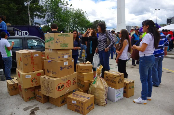 Quito, Ecuador - April,17, 2016: Unidentified citizens of Quito providing disaster relief food, clothes, medicine and water for earthquake survivors in the coast
