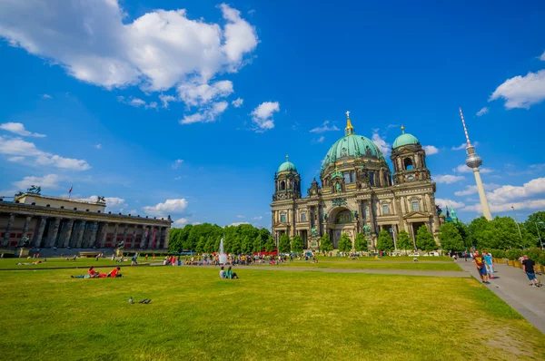 BERLIN, GERMANY - JUNE 06, 2015: The imposing Cathedral of Berlin at the bottom, large green grass with people on summer
