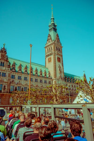 HAMBURG, GERMANY - JUNE 08, 2015: City hall view from a drop on and drop off bus, emblematic buiding. Clock in the middle