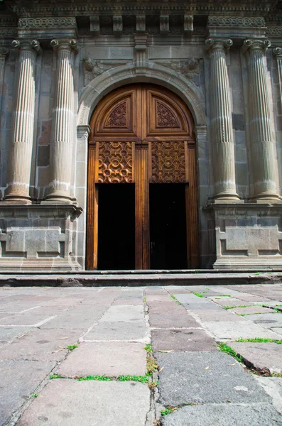 Wooden door leading into beautiful church of Guapulo located in Quito Ecuador, spanish colonial architecture and blue sky background