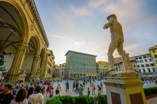 FLORENCE, ITALY - JUNE 12, 2015: Lots of tourists walking around Piazza della Signoria in the center of Florence