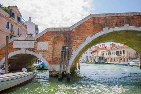 VENICE, ITALY - JUNE 18, 2015: Interesting down part of bridge in Venice, water flowing. Water transportation