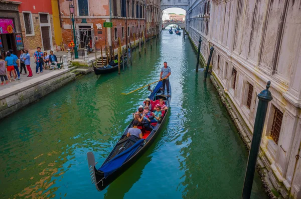 VENICE, ITALY - JUNE 18, 2015: Beautiful view of people meeting Venice on gondola transportation, water ways with a sunny nice day