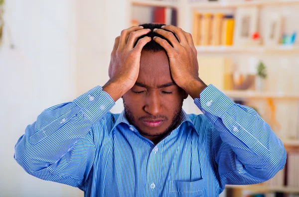 Man holding his head with both hands, pensative and stress face
