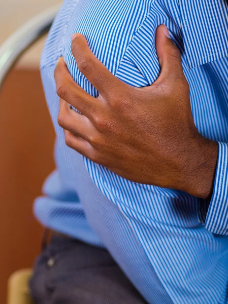 Close up of hand holding a shoulder, strong pain