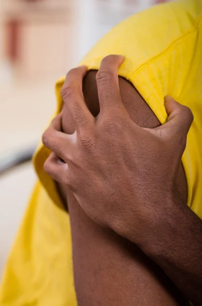 Close up of pain shoulder, man holding with his hand trying to make a massage
