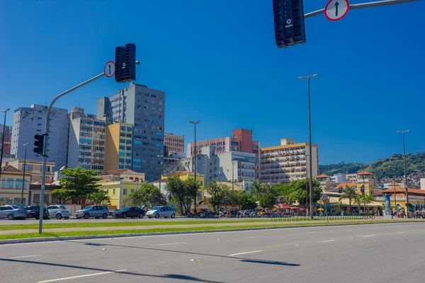 FLORIANOPOLIS, BRAZIL - MAY 08, 2016: lot of motorcycles and cars parked on the side of the street in front of some stores withe the buildings as background