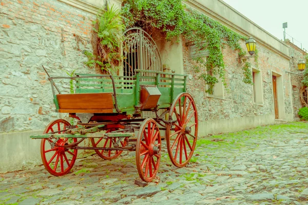 COLONIA DEL SACRAMENTO, URUGUAY - MAY 04, 2016: nice entrance of an ancient house with an old cart parked in the street