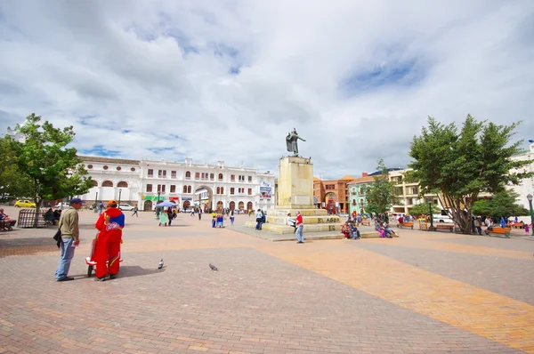 PASTO, COLOMBIA - JULY 3, 2016: pedestrians walkin on the central square where a statue of antonio narino is located