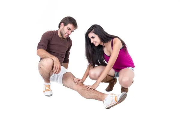Young man stretching with female personal trainer