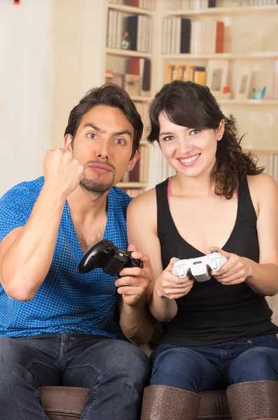 Young cute couple playing video games