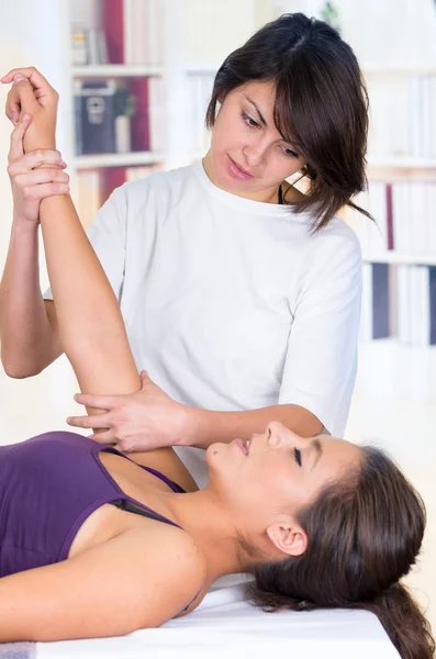 Woman lying while getting a massage concept of physiotherapy