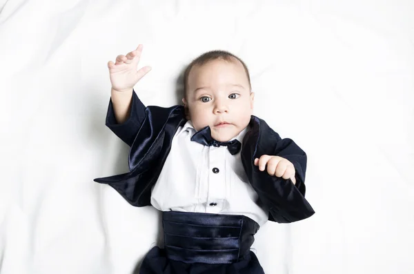 Cute baby boy wearing an elegant suit with bow tie