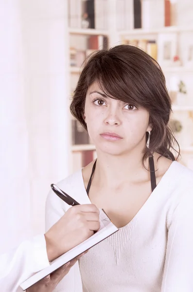 Beautiful young girl looking nervous at the doctors appointment