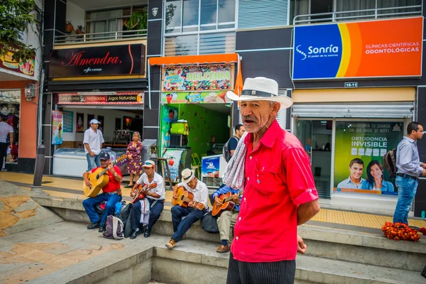 Unidentify indigenous man that works coffee plantation shopping in the main commercial street of Armenia, Colombia