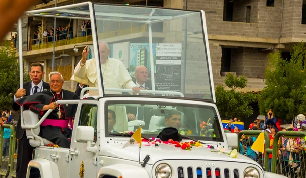 Front side angle Pope Francis motorcade driving through city crowds of people cheering to start off official South America tour his first stop Quito, Ecuador,