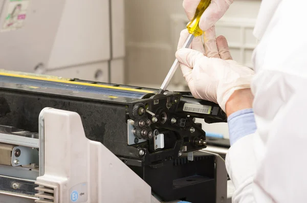 Closeup shot technician fixing photocopier machine