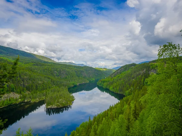 VALDRES, NORWAY - 6 JULY, 2015: Beautiful view over Begna river seen from above, large green forest and dark blue water nice weather