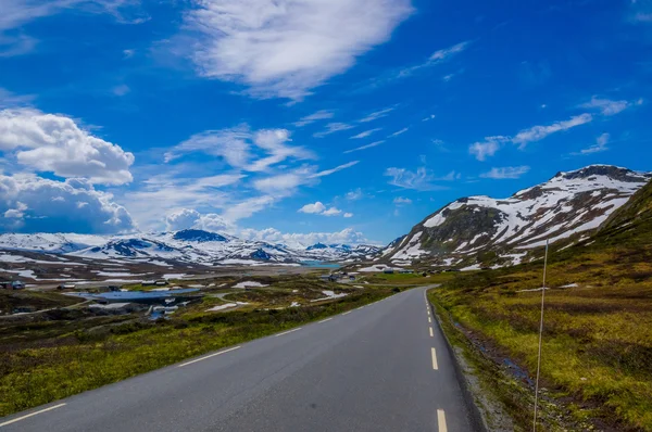 VALDRES, NORWAY - 6 JULY, 2015: Beautiful road passing through Valdresflya mountain range sorrounded by stunning nature