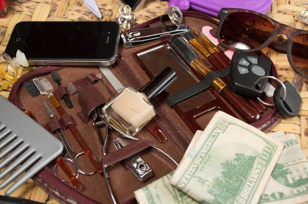 Personal belongings of typical woman, daily life concept, mobile phone, car keys, glasses and money spread out