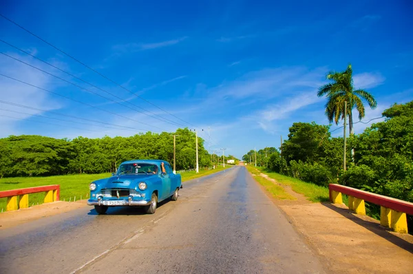 CENTRAL ROAD, CUBA - SEPTEMBER 06, 2015: American Oldtimer in the rural road system used for transportation