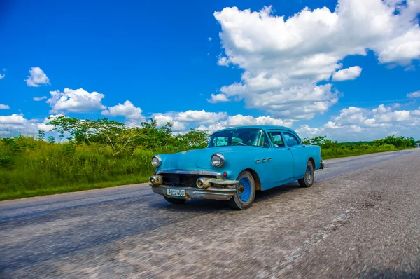 CENTRAL ROAD, CUBA - SEPTEMBER 06, 2015: American Oldtimer in the rural road system used for transportation