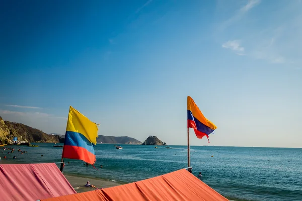 Beautful view of colombian flags in Playa Blanca beach, Santa Marta, Colombia