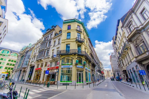 BRUSSELS, BELGIUM - 11 AUGUST, 2015: Very charming corner building beautiful  architecture, road crossing in front with some businesses locaed at ground floor