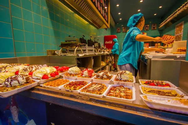 BRUSSELS, BELGIUM - 11 AUGUST, 2015: Inside a belgian waffle store, many delicious plates lined up with different toppings such as chocolate, cream, berries and caramel