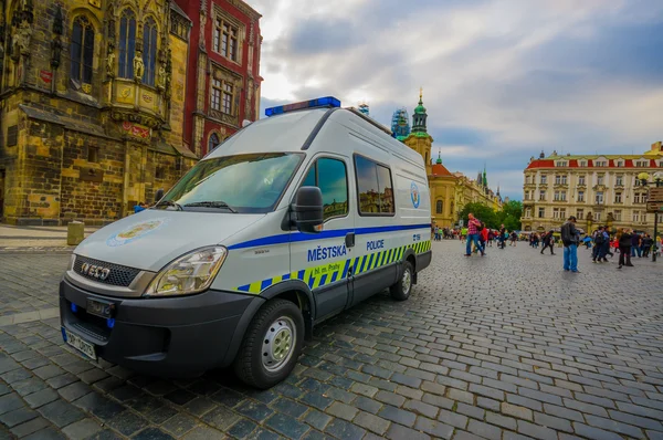 Prague, Czech Republic - 13 August, 2015: Police car passing over Old Town Square on a nice day, seen from street level