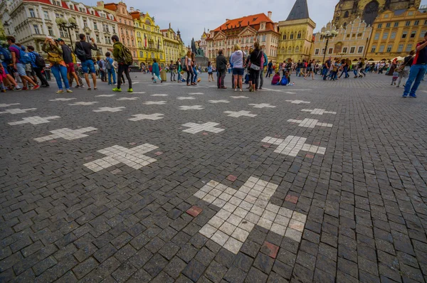 Prague, Czech Republic - 13 August, 2015: Steet view from lively and beautiful old town square, pattern of white crosses on bridgestone surface
