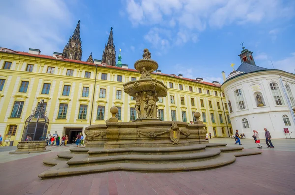 Prague, Czech Republic - 13 August, 2015: Beautiful water fountain located on city square with towers from St. Vitus in background