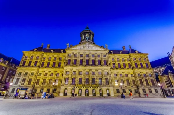 Amsterdam, Netherlands - July 10, 2015: The incredible royal palace as seen across from Dam Square in a beautiful evening light