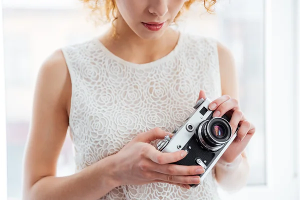 Woman photographer holding vintage camera