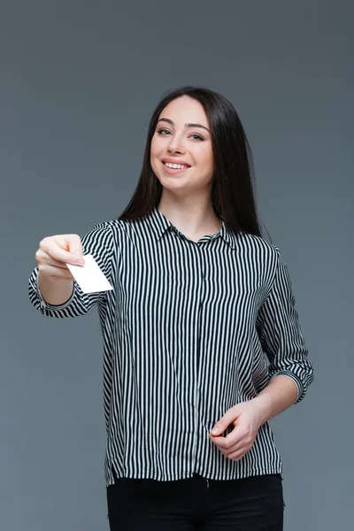 Attractive woman giving blank card at camera