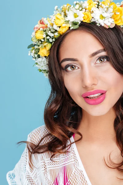 Close-up portrait of an attractive brunette wearing flower diadem