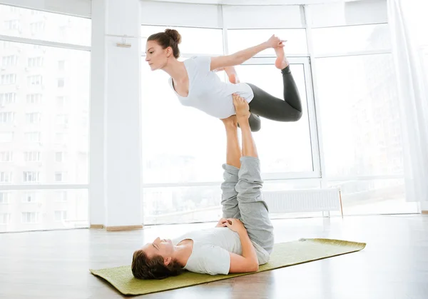 Beautiful couple balancing and doing acro yoga