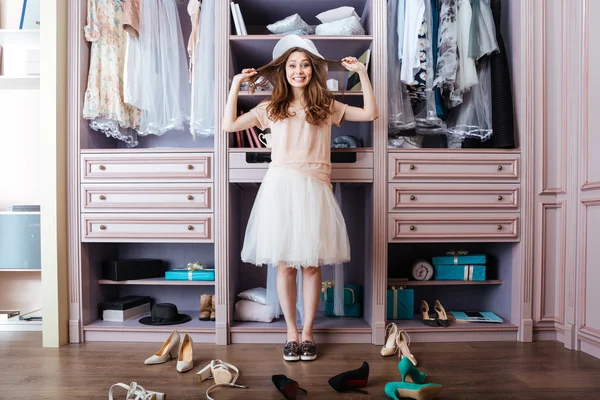 Girl choosing shoes in her wardrobe