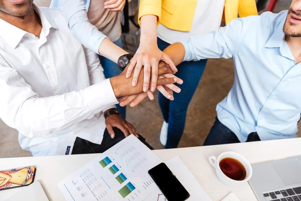 Group of business people joining hands