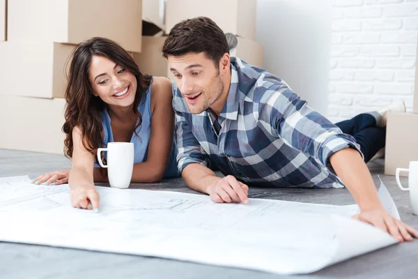 Happy couple looking at construction house plan