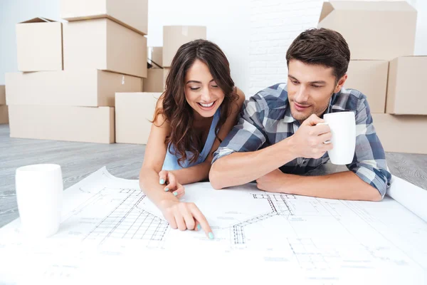 Happy couple looking at construction house plan