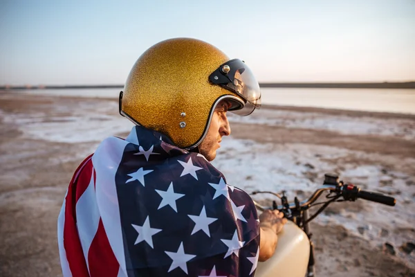 Close up portrait of man wearing helmet and american flag