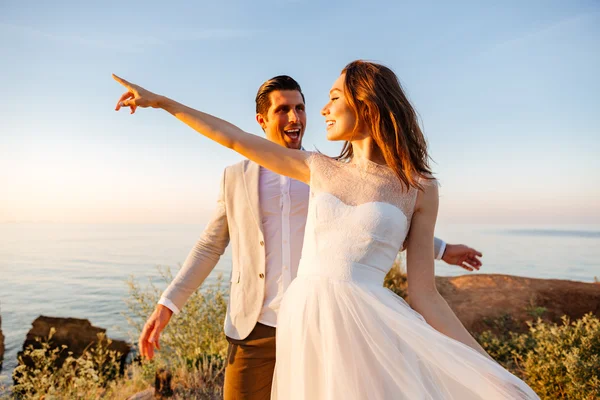 Attractive bride and groom getting married by the beach